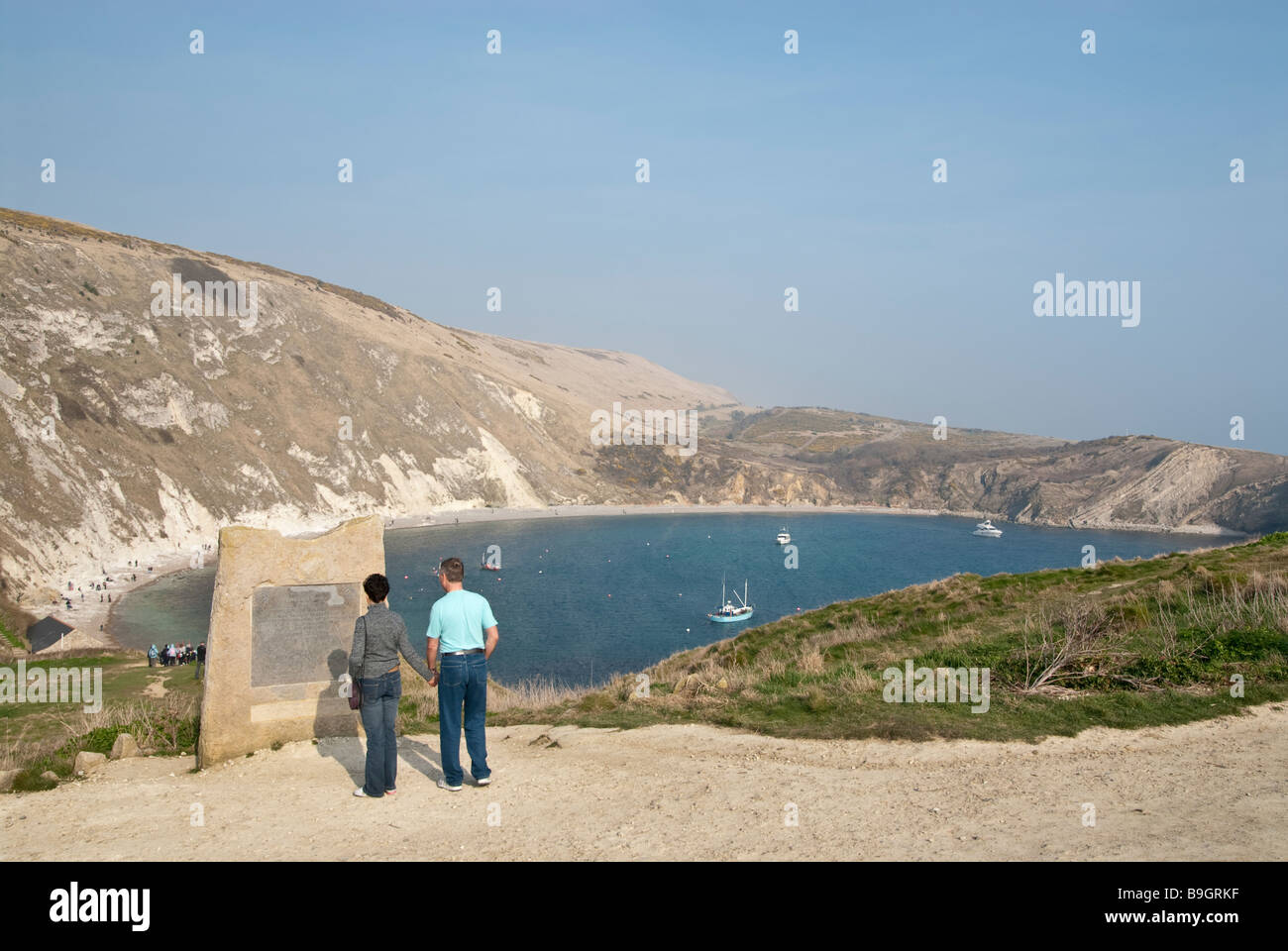 Viewing World Heritage commerative stone at Lulworth Cove Stock Photo
