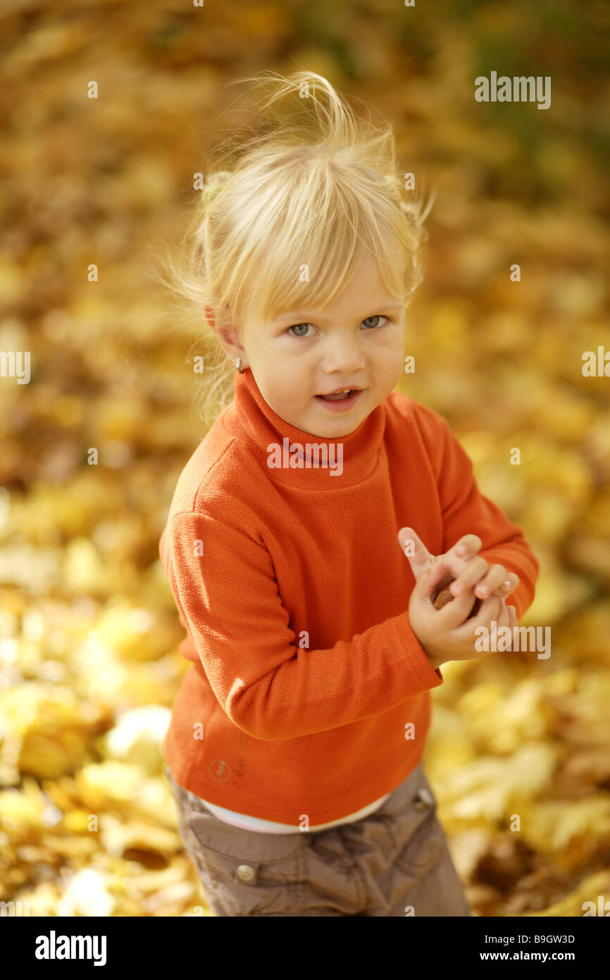 Forest child fall foliage running happy Stock Photo