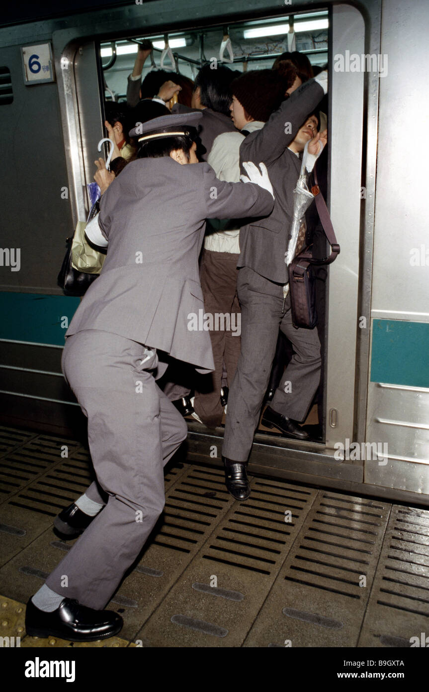 Japan Tokyo Rushhour subway overfills conductors crowd Asia push East-Asia Honshu Tokyo capital track train railway station Stock Photo