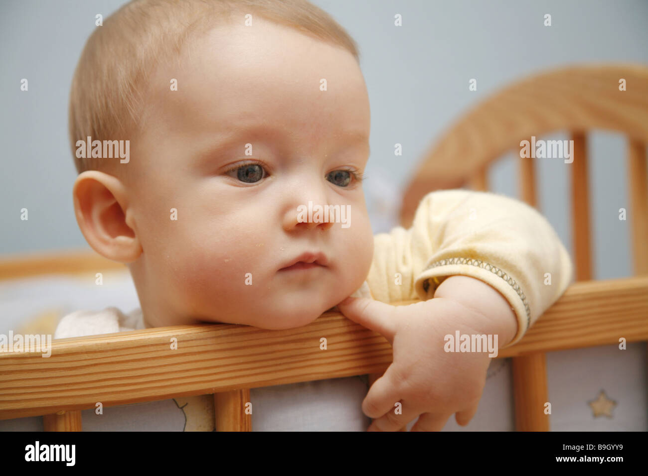 Little baby in a child bed Stock Photo