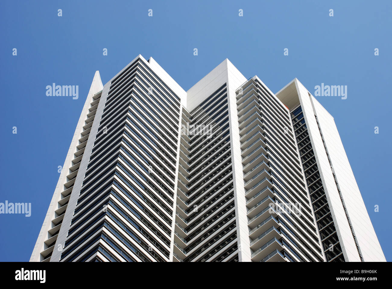 High rise building against blue sky Stock Photo - Alamy