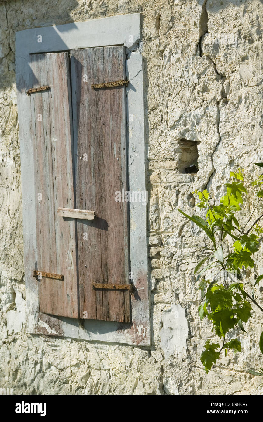 House wall windows shutters old detail residence house-wall stone-wall stone-construction-manner needing refurbishment decrepit Stock Photo