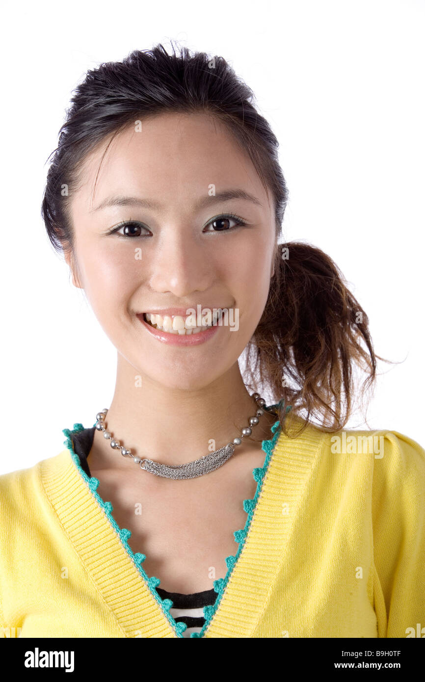 One young woman smiling against white background Stock Photo - Alamy
