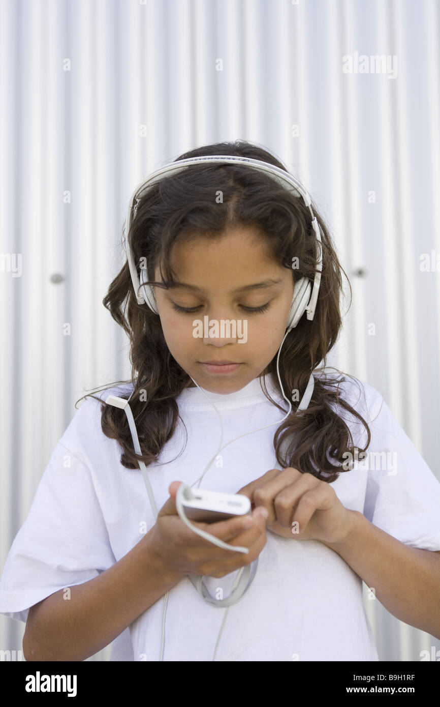 girl headphones Mp3 music semiportrait hear outside 1012 years 11