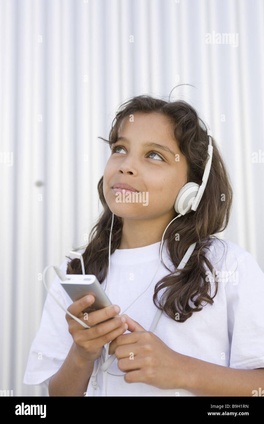 girl smiling headphones Mp3 music hears semiportrait outside 1012