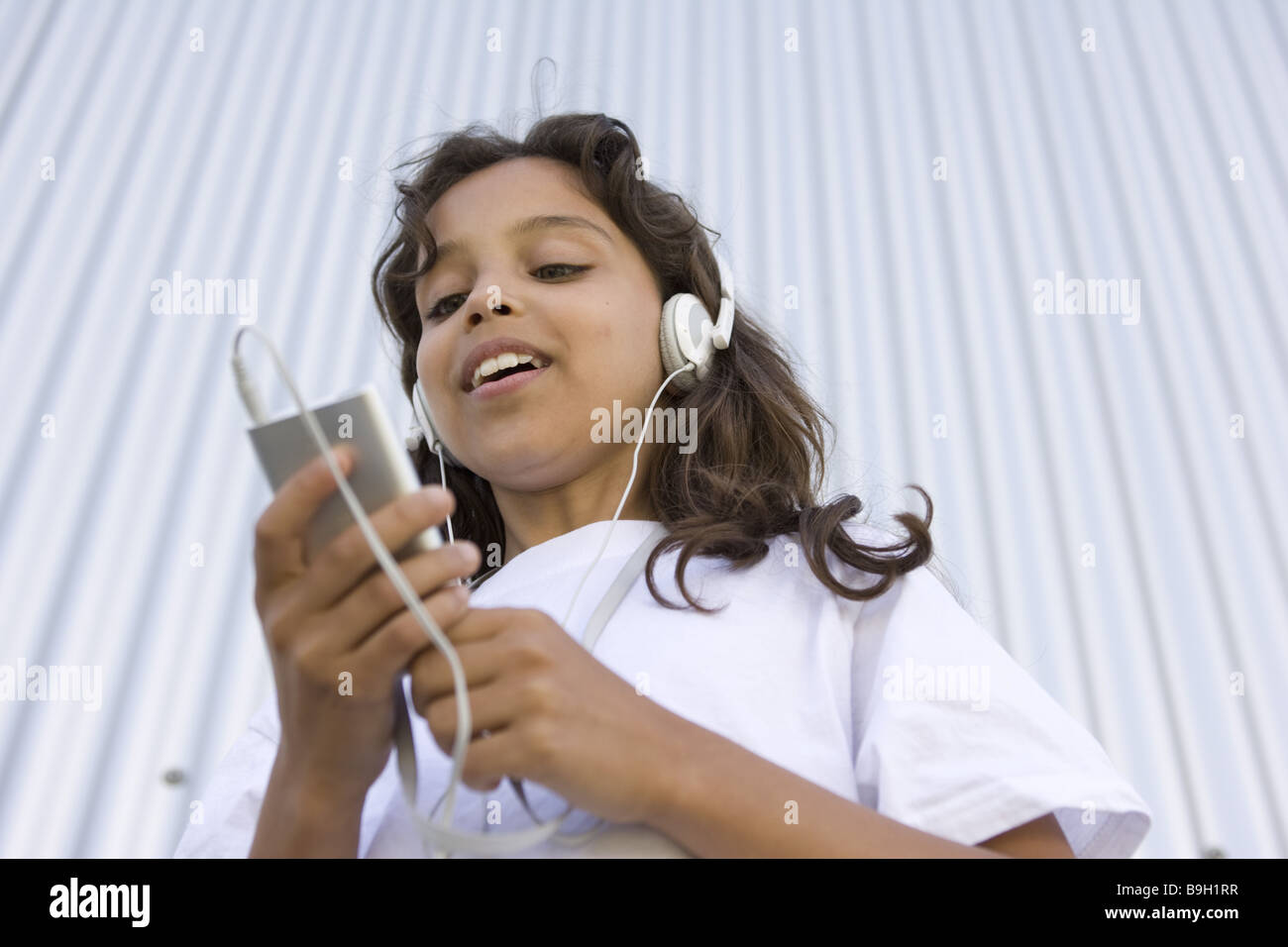 girl headphones Mp3 music semiportrait hear outside 1012 years 11