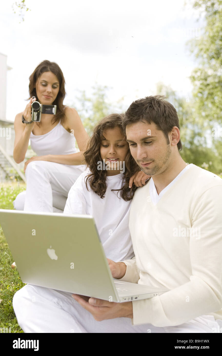 Family films looks smiling camcorders laptop outside semiportrait 10