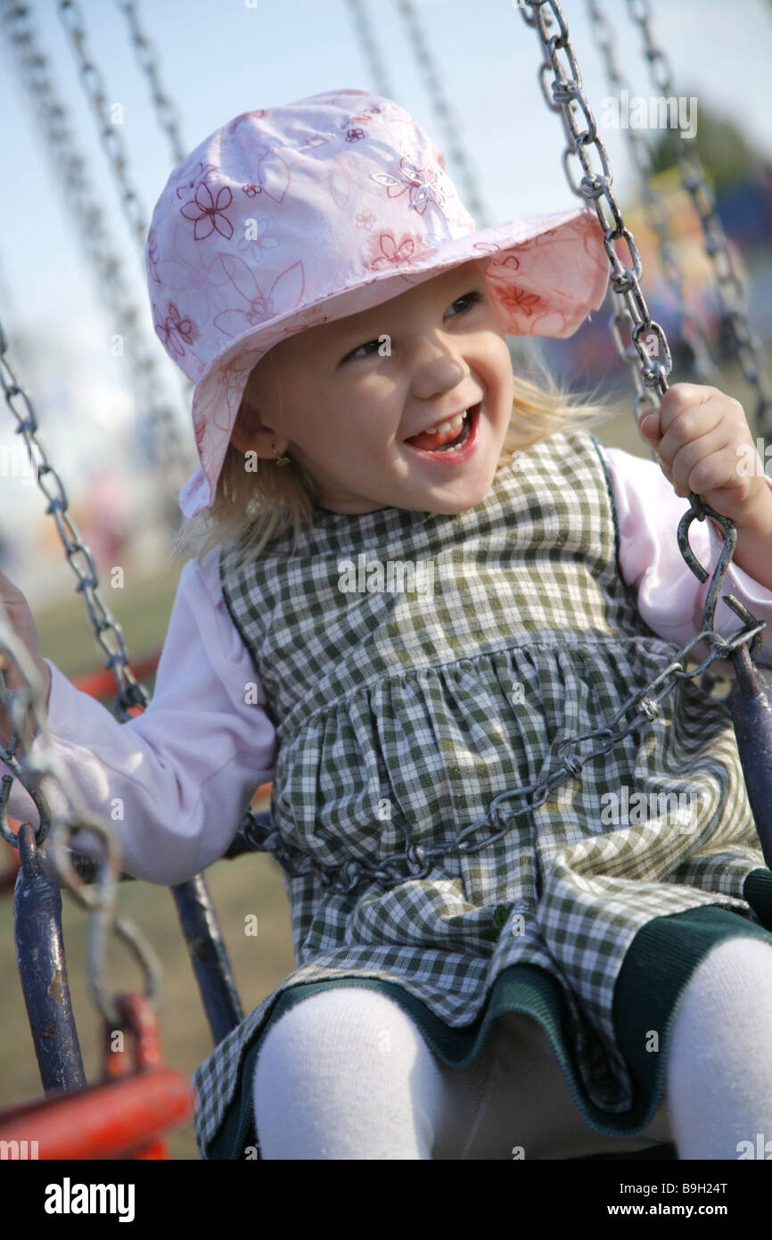 Little girl having fun on carousel Stock Photo