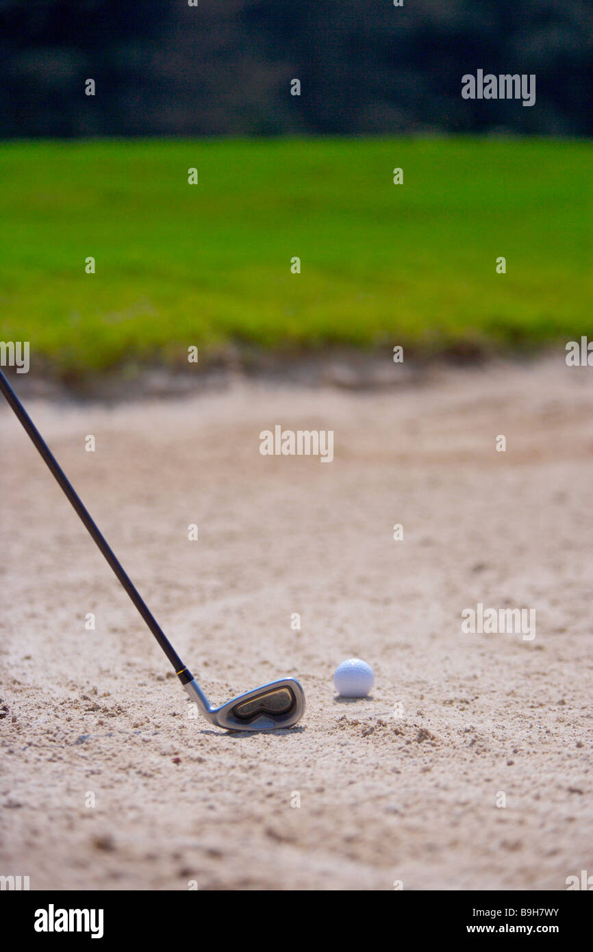 Close up of a golf club and a golf ball in sand trap Stock Photo Alamy