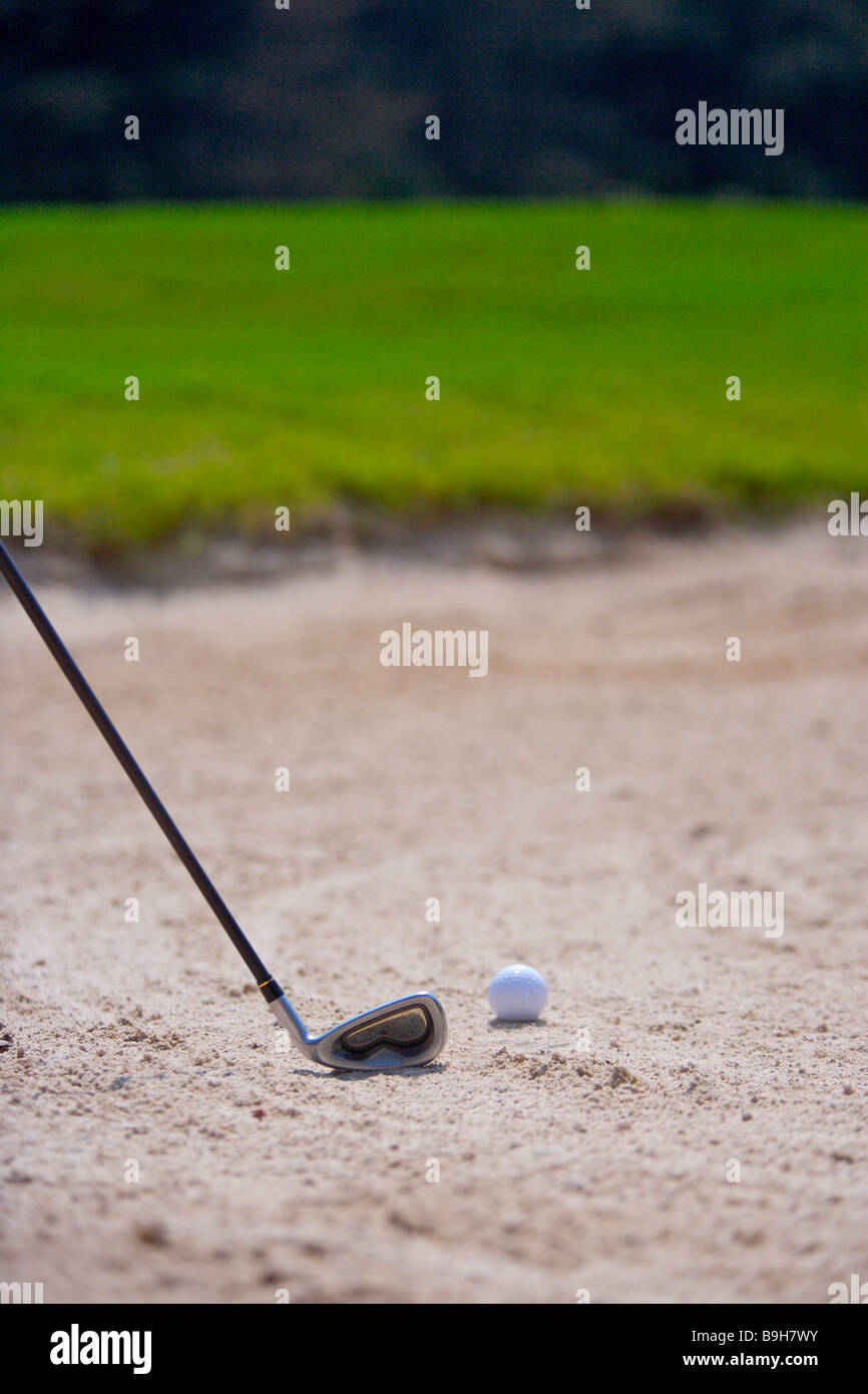 Close up of a golf club and a golf ball in sand trap Stock Photo - Alamy