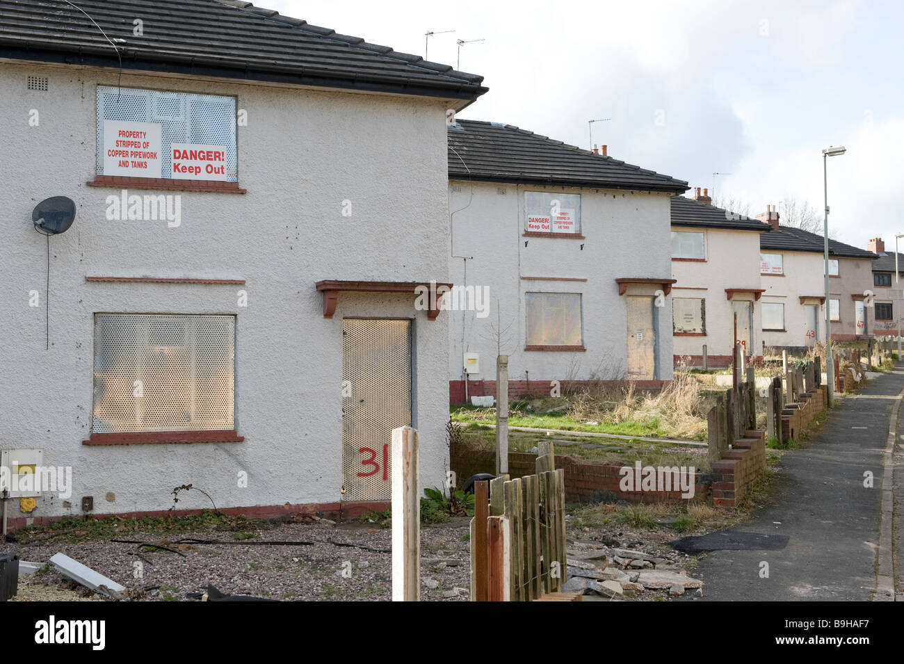 A row of empty derelict houses on a derelict housing estate near