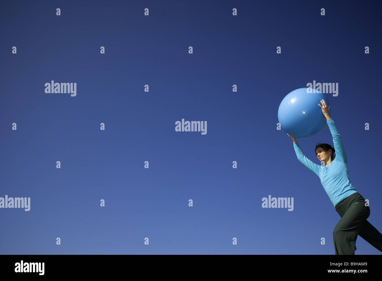 Woman sport fitness movement gymnasticsball outside 24 years arm poor