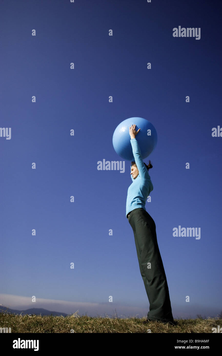 Woman sport fitness movement gymnasticsball outside 24 years arm poor