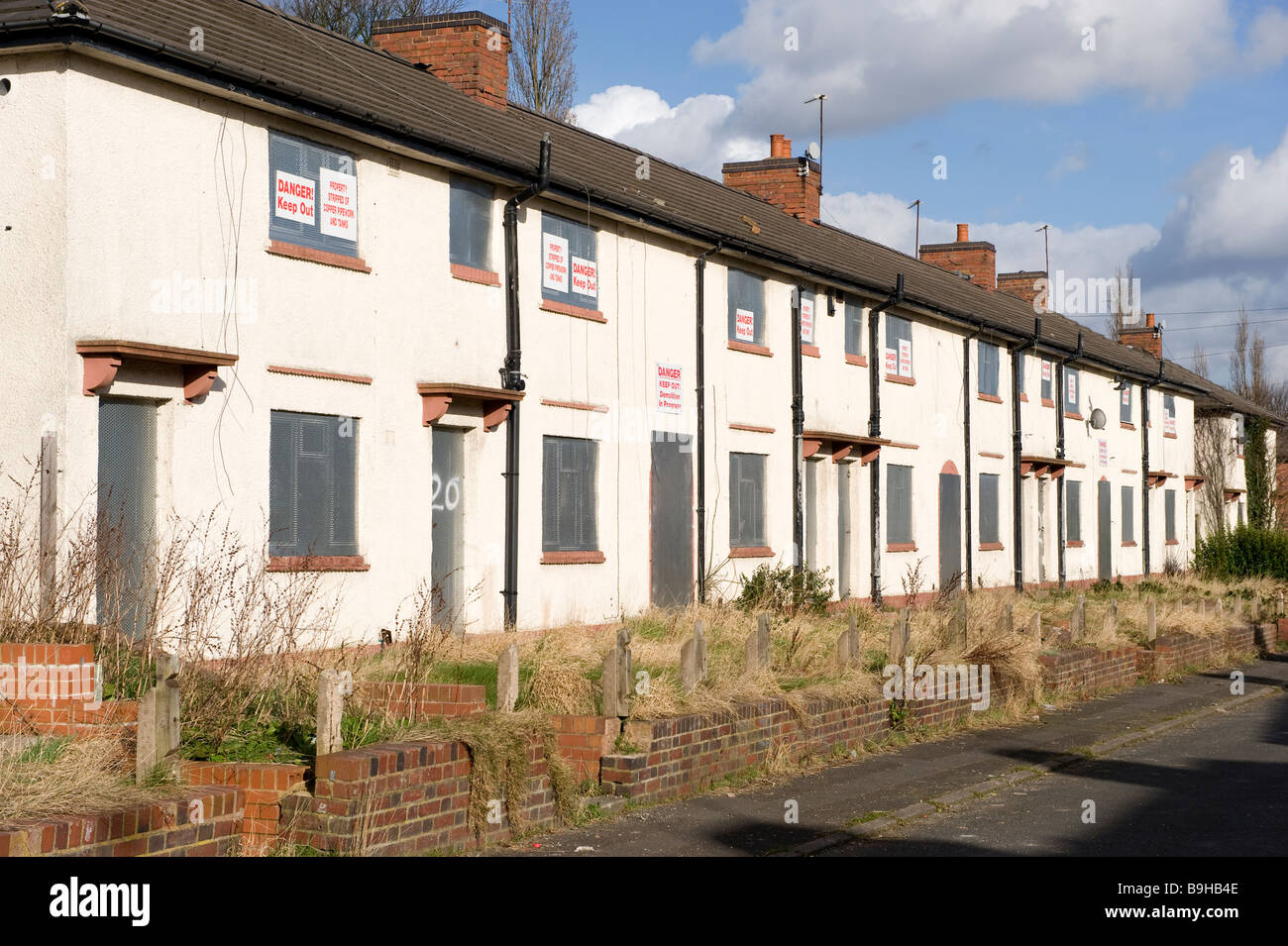 A row of empty derelict houses on a derelict housing estate near