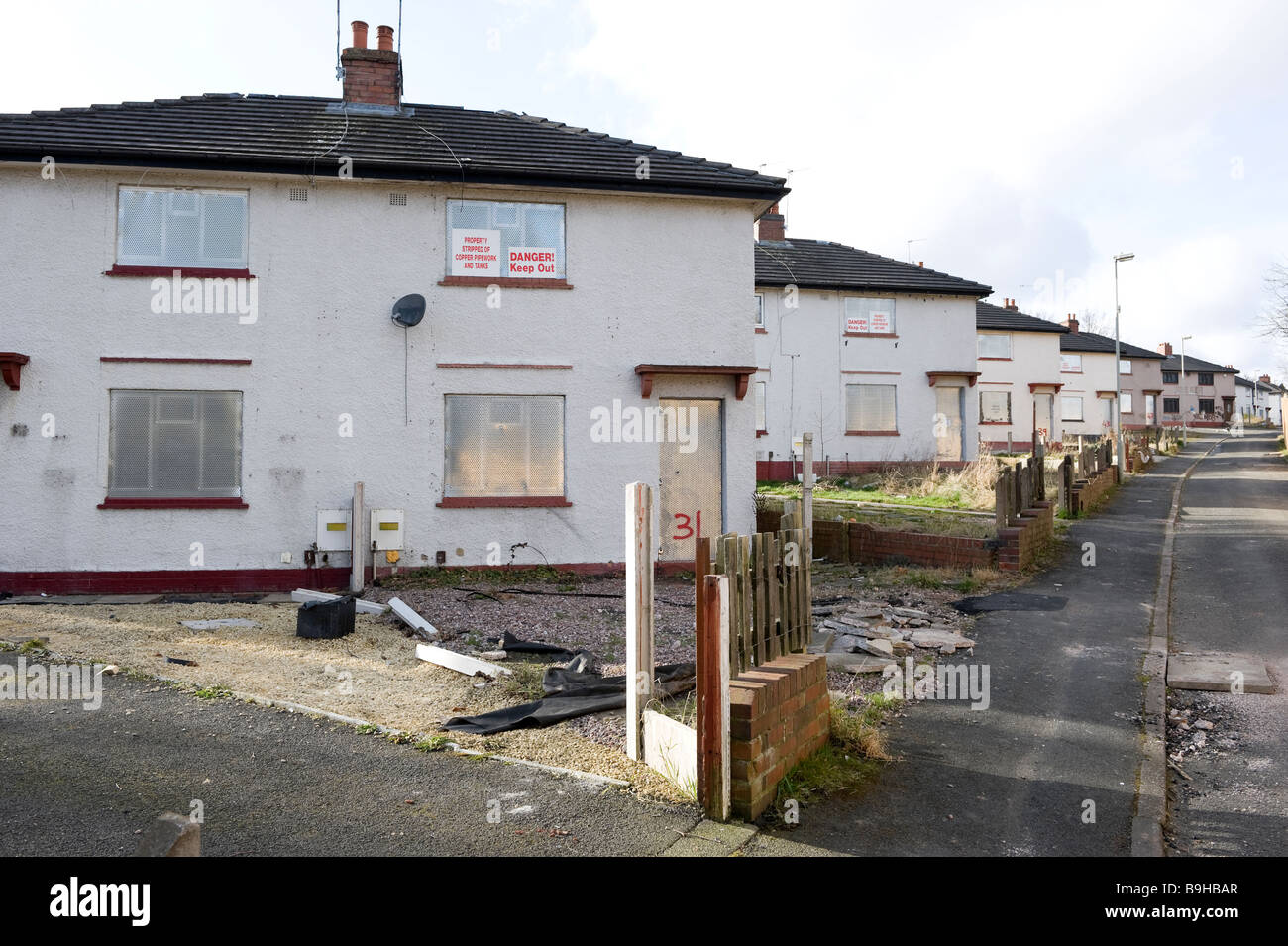 A row of empty derelict houses on a derelict housing estate near