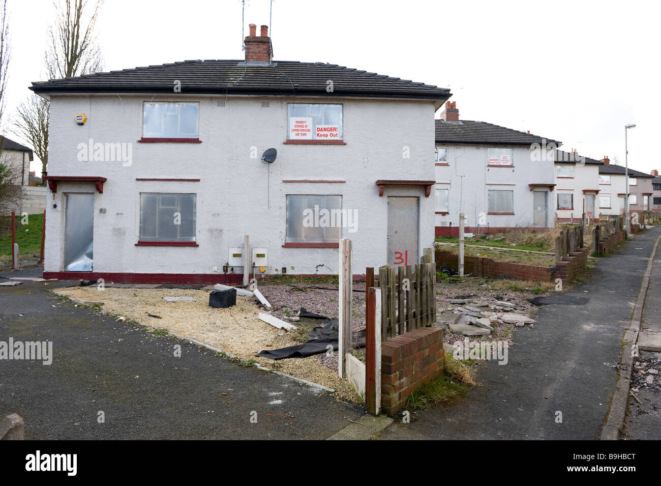 A row of empty derelict houses on a derelict housing estate near
