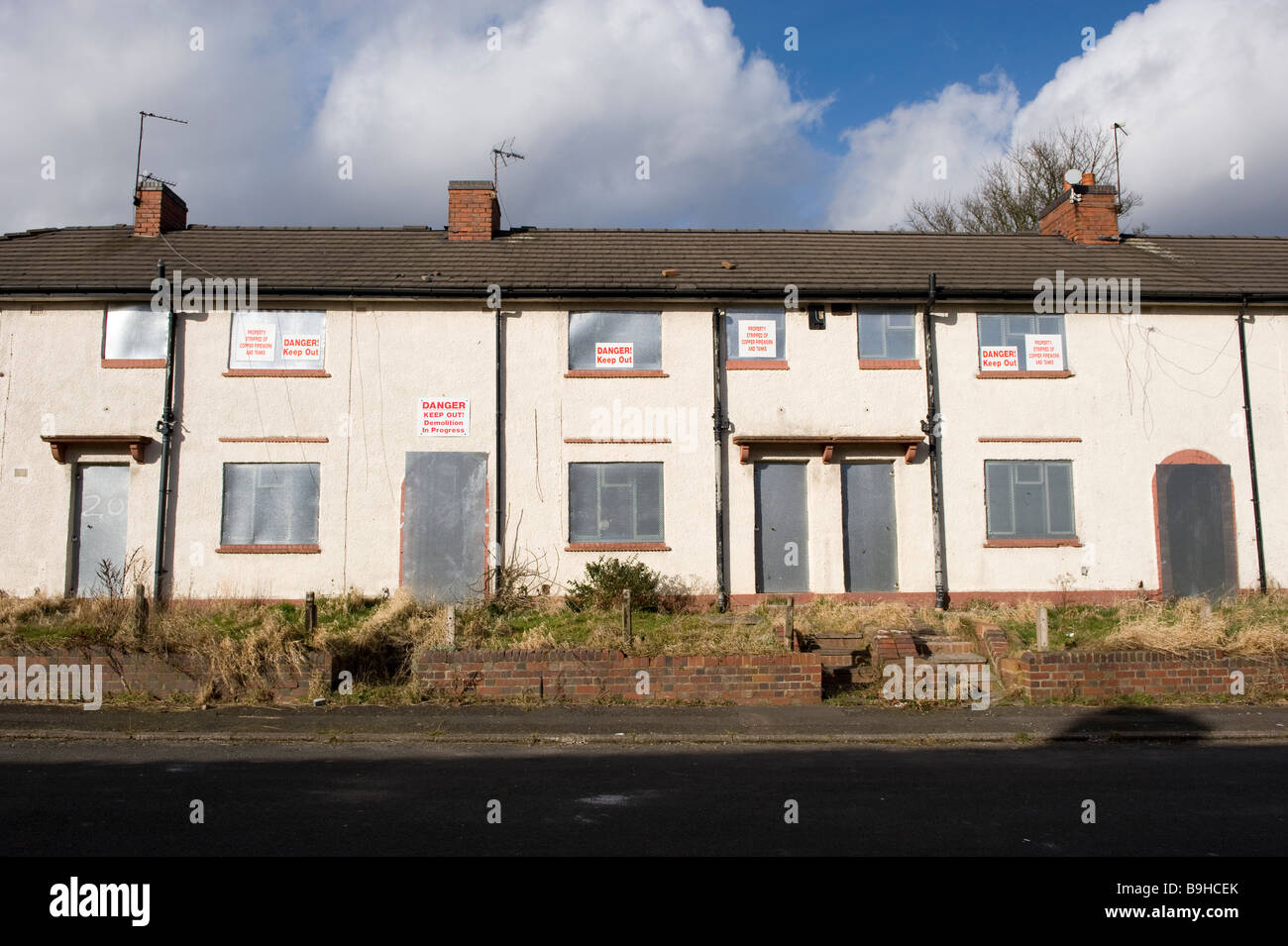 A row of empty derelict houses on a derelict housing estate near