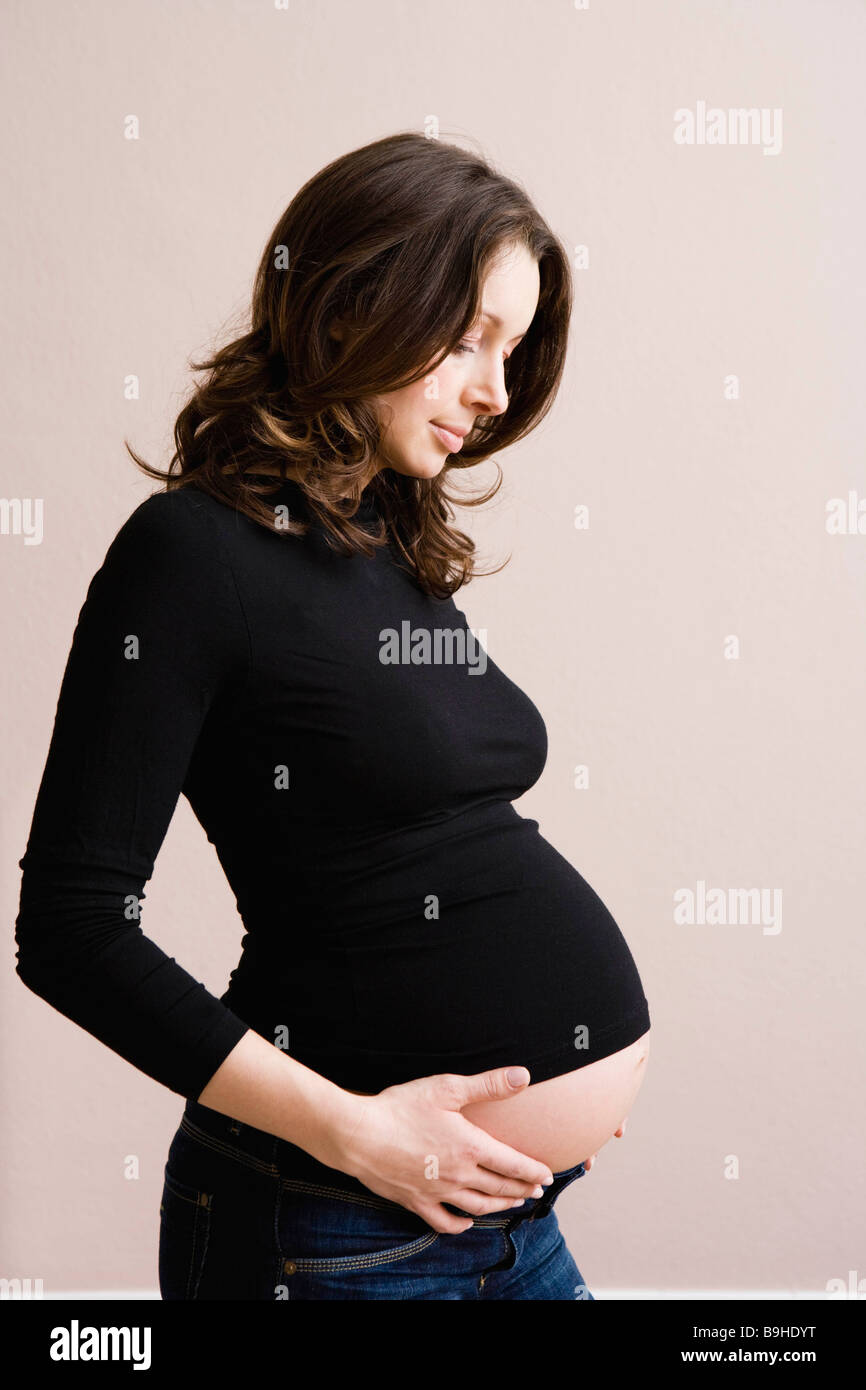 Pregnant woman holding her belly Stock Photo - Alamy