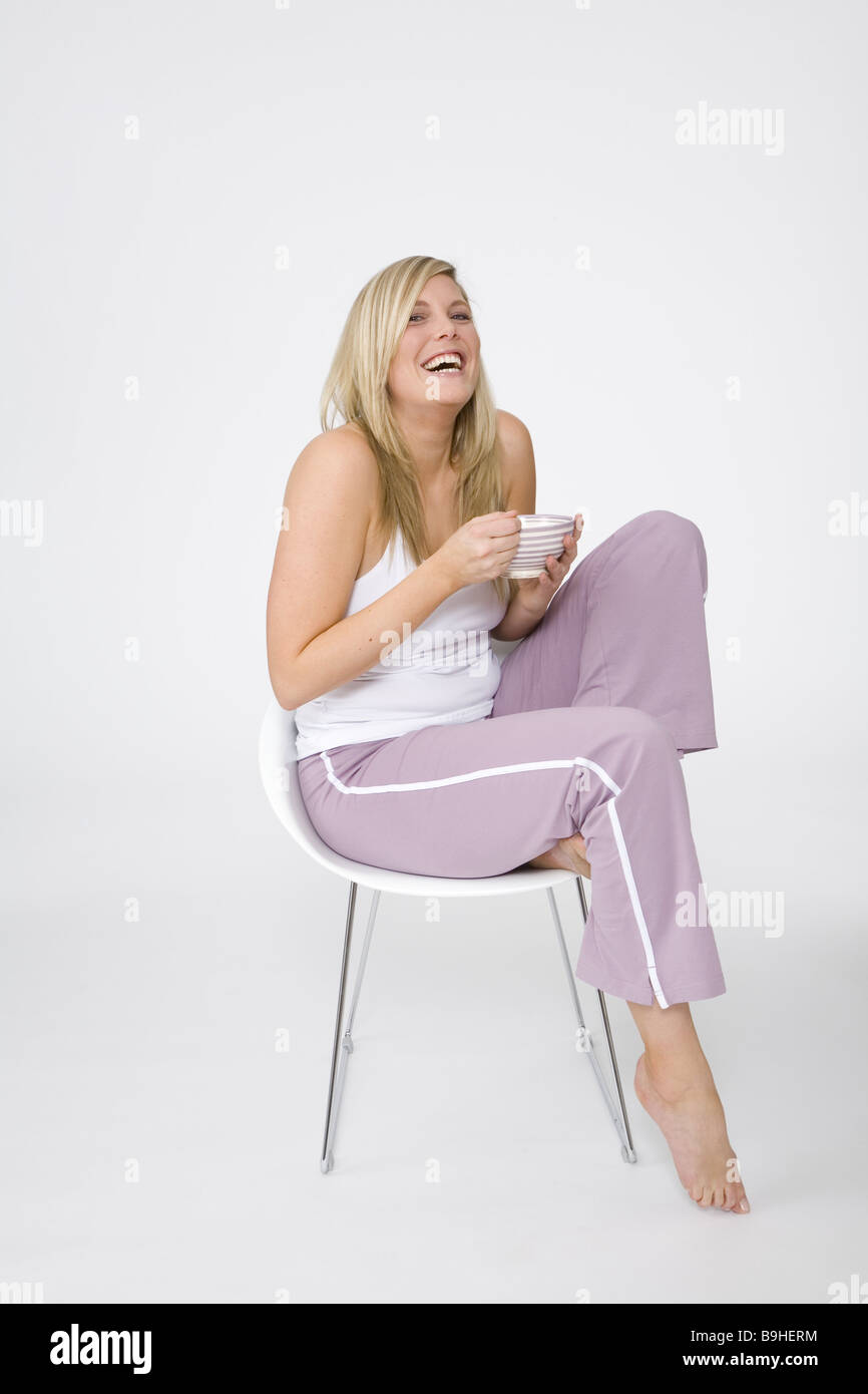woman young cozy chair sitting laughing muesli eating series people 30-40 years blond long-haired stout overweight jogging Stock Photo