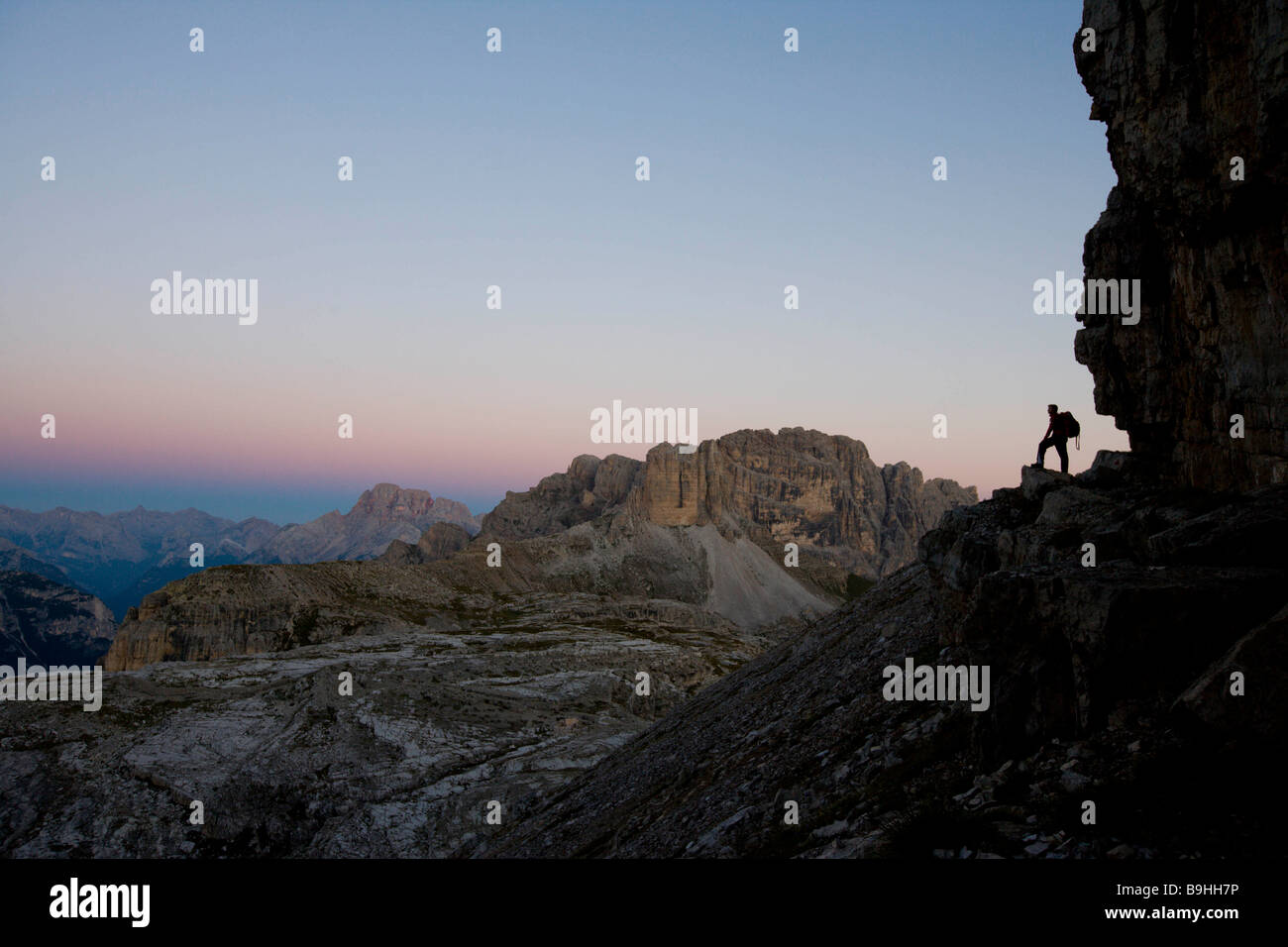 Man standing at flank of a mountain Stock Photo