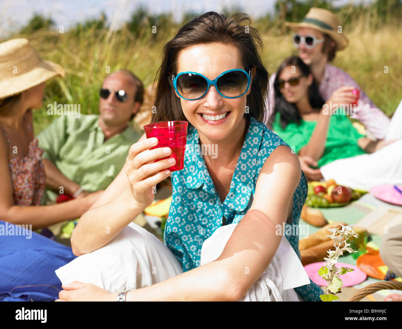 Friends having a picnic in a field Stock Photo Alamy