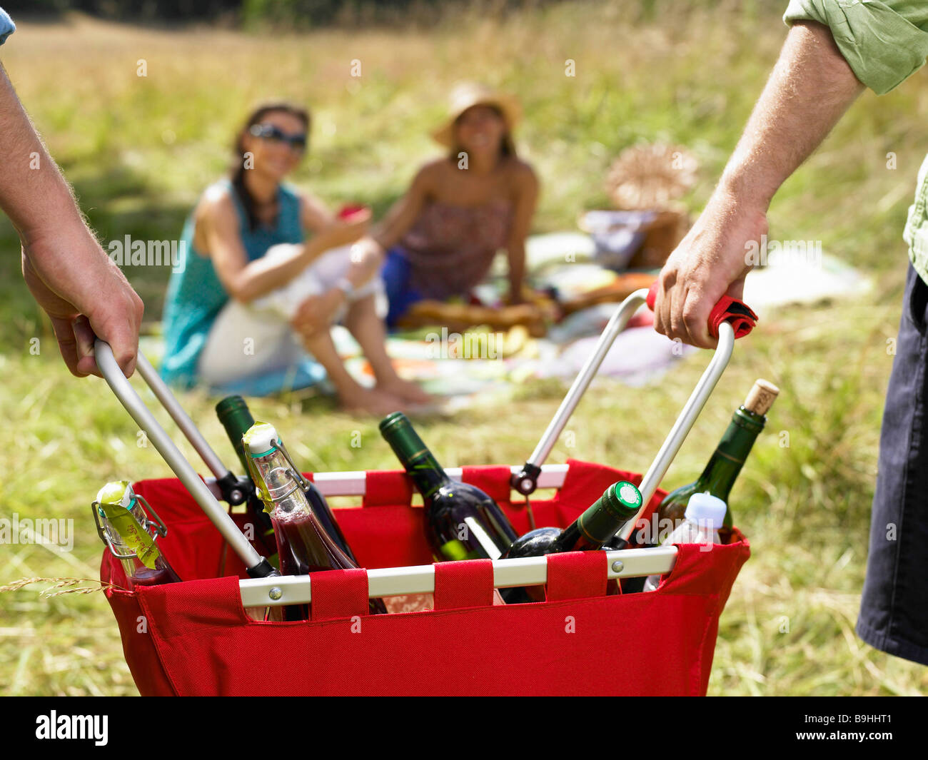 Friends having a picnic in a field Stock Photo Alamy