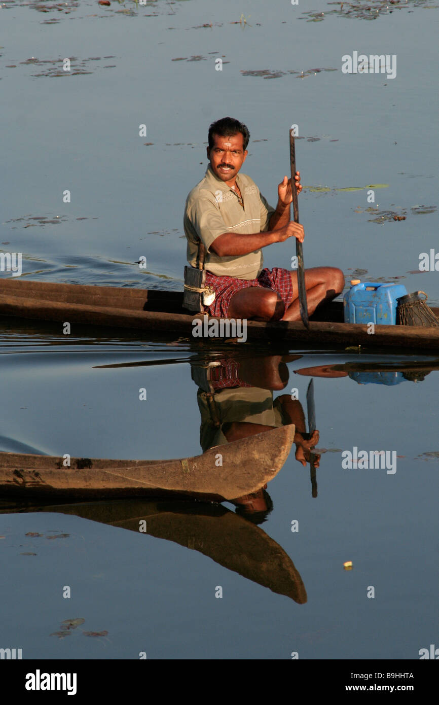 Indian man in wooden canoe in the Kerala backwaters Stock Photo