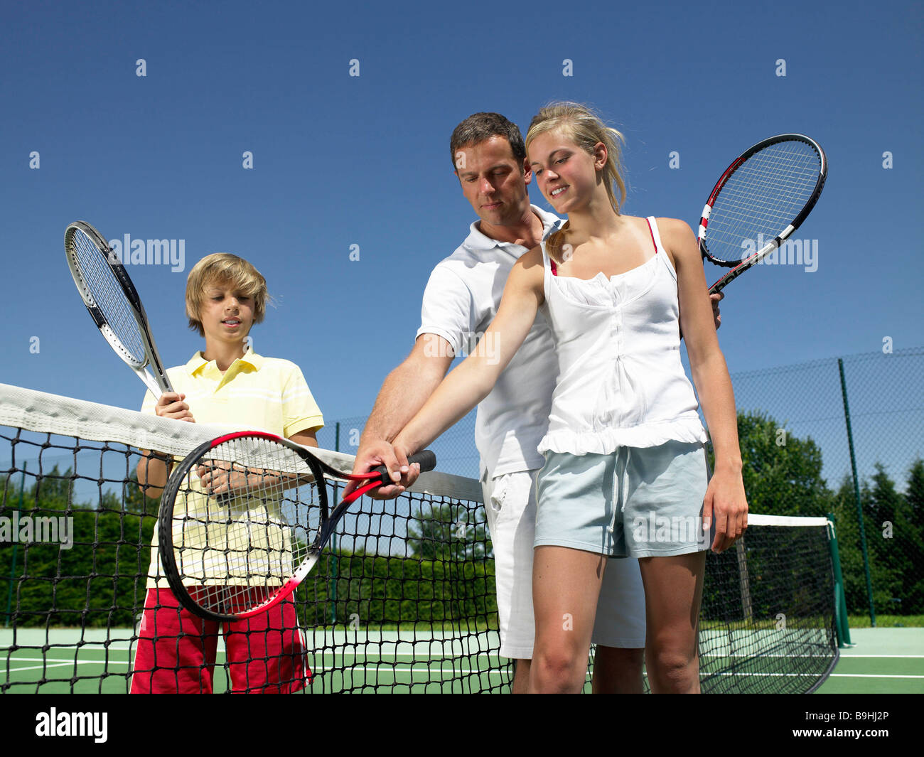 Tennis lesson under the heat Stock Photo