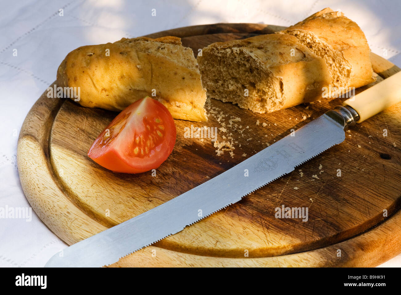 Bread, bread knife, tomato, bread board Stock Photo Alamy