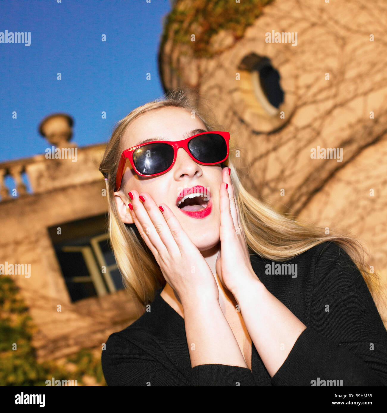 Blond woman with red glasses Stock Photo