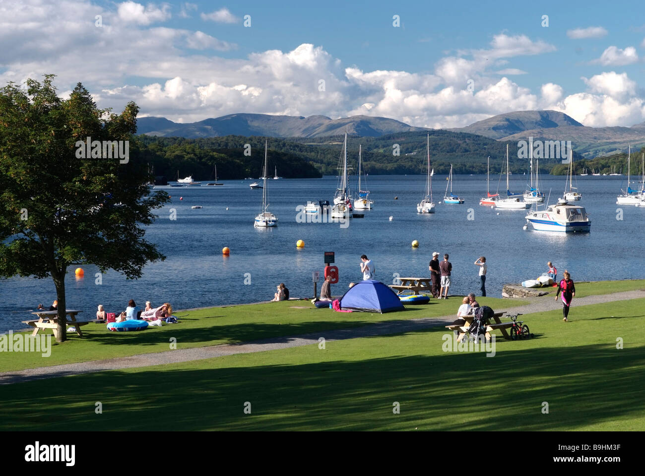 Lake and boats, waterside lawn and people, Lake Windermeere, Lake District, Great Britain, Europe Stock Photo