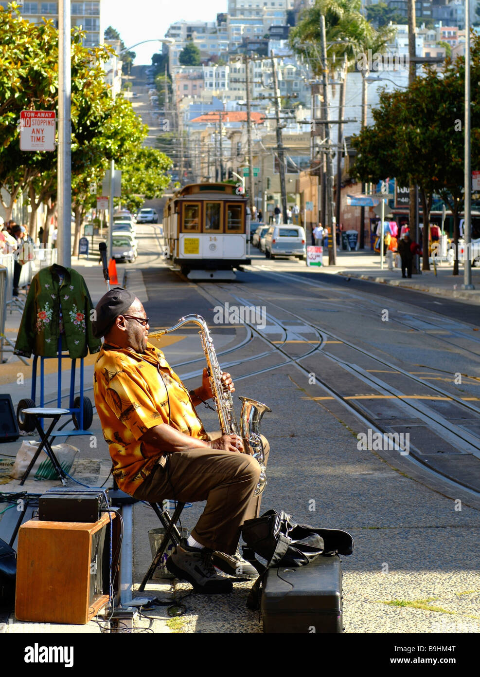 Street musician playing saxophone, streetcar stop, San Francisco, California, USA Stock Photo