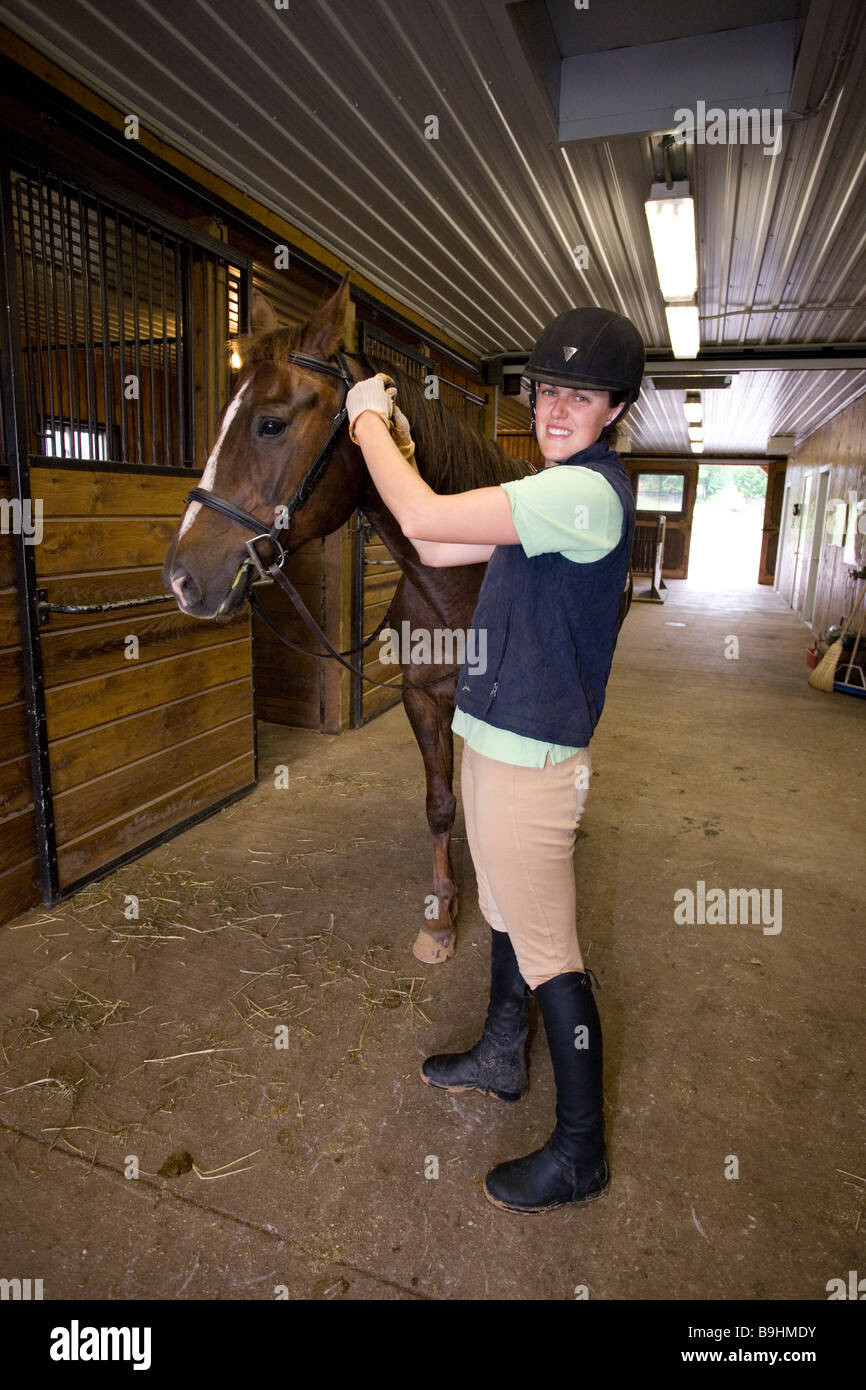 North America Canada Ontario Teenage Girl Putting Bridle On Horse