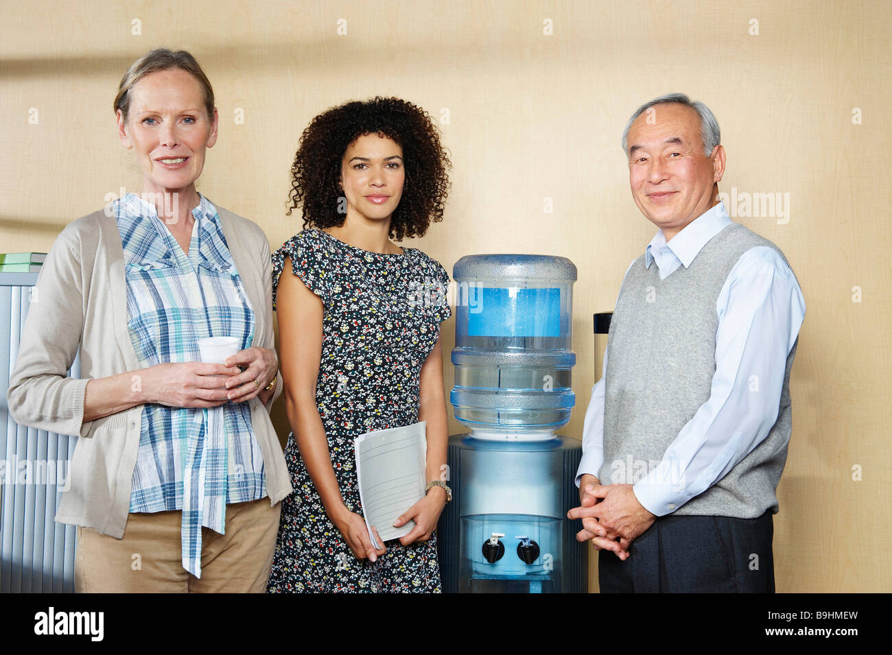 Portrait of coworkers by water cooler Stock Photo Alamy