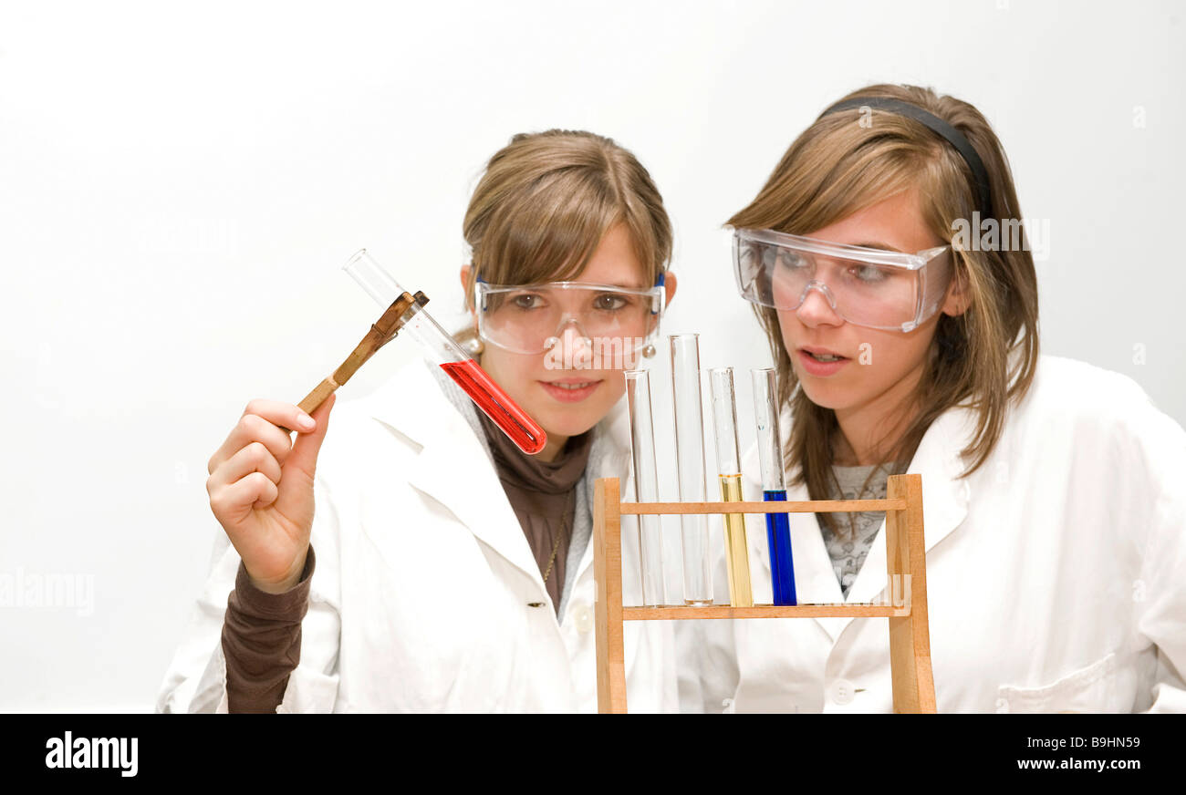 Adolescents wearing safety glasses in a chemistry lesson, using test