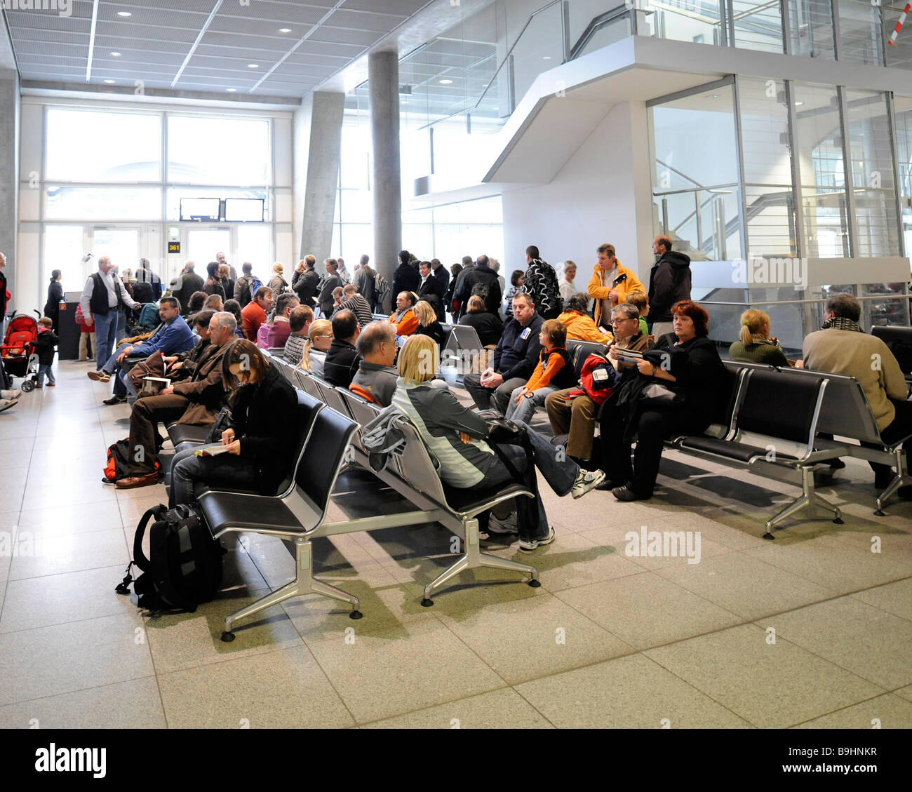 Airline passengers in the waiting area at a boarding gate, Stuttgart ...