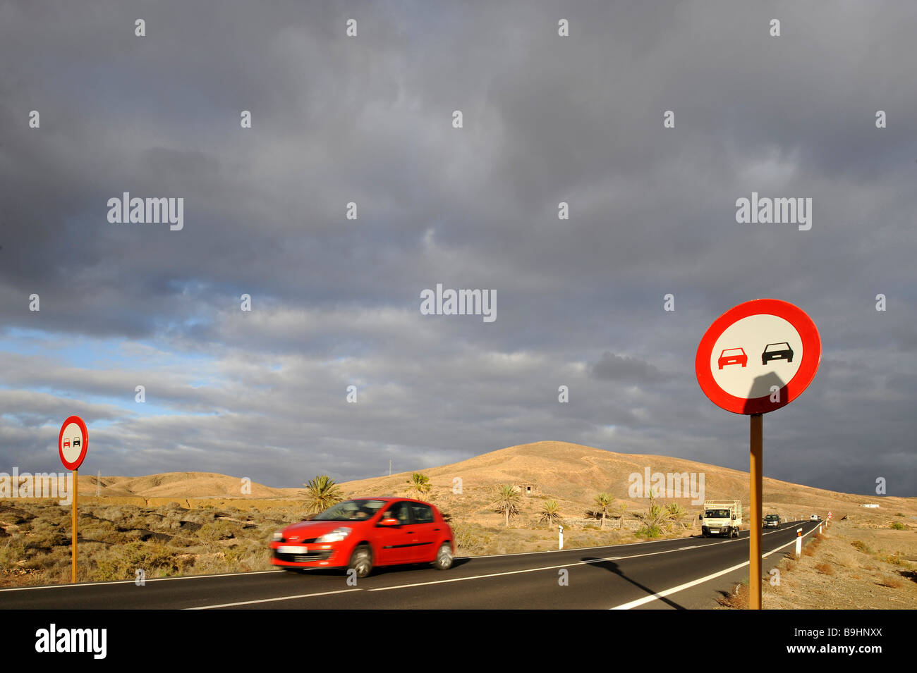 Cars on a road and no overtaking sign in Fuerteventura, Canary Islands, Spain, Europe Stock Photo