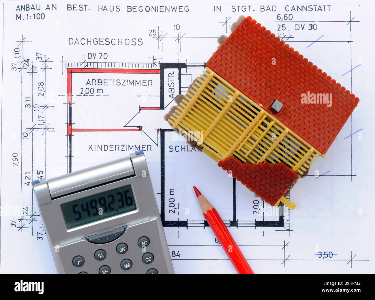 Miniature house, construction plan, calculator, red pencil, symbolic picture for home ownership Stock Photo