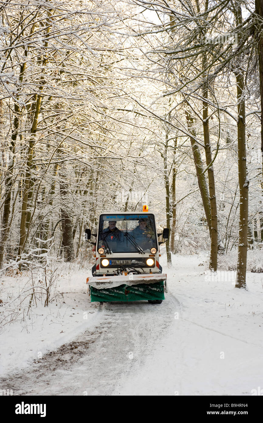 Snowclearing vehicle on a snowcovered path Stock Photo Alamy