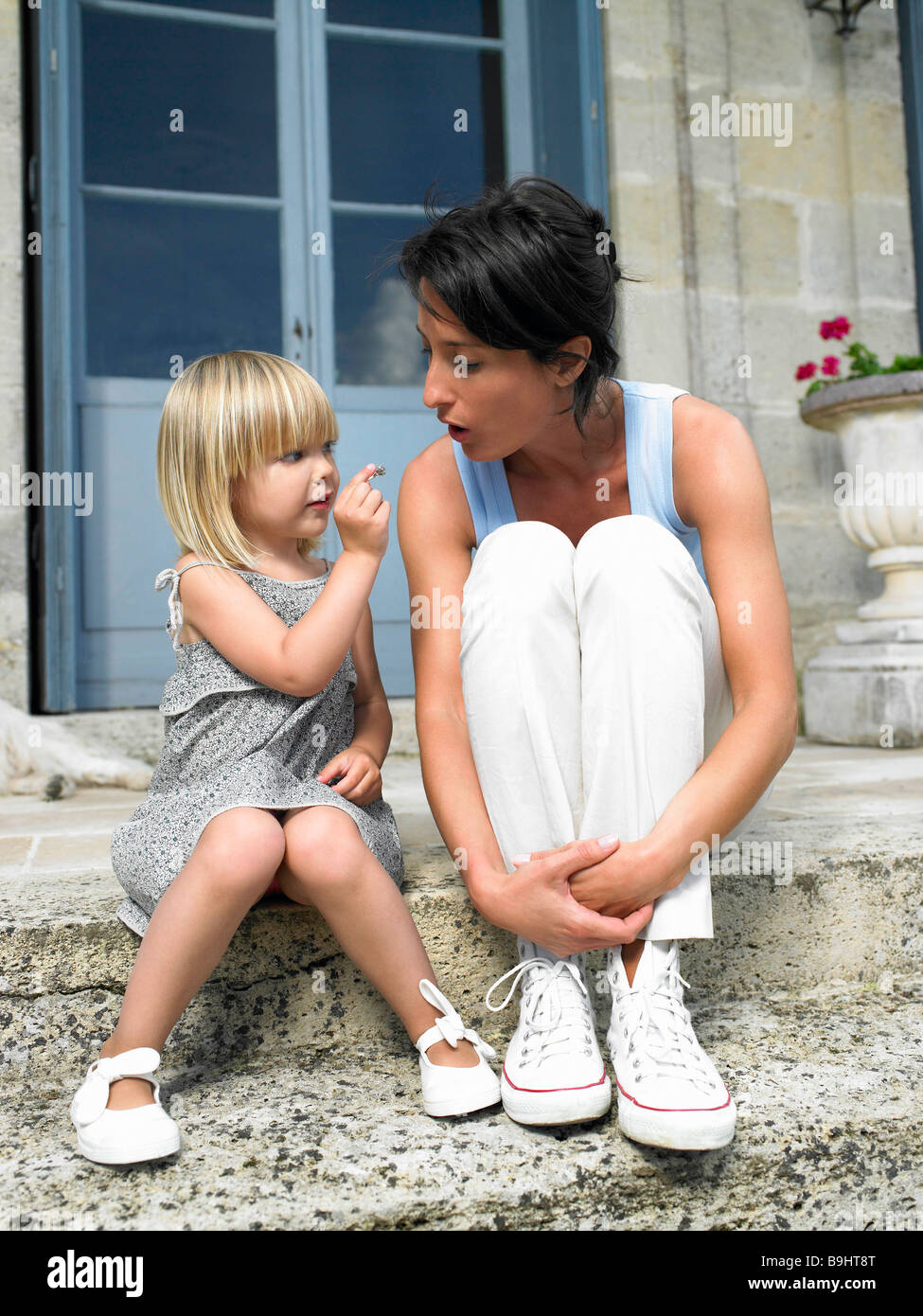 Mother and daughter on door step Stock Photo