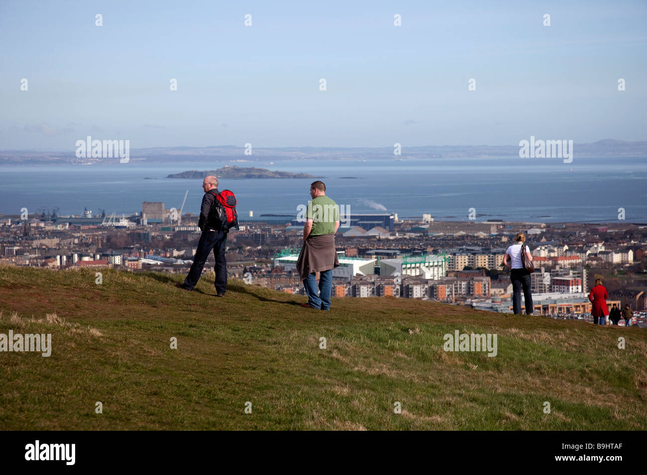 Two Males looking out over the city of Edinburgh Scotland, UK, Europe from above Holyrood Park Stock Photo