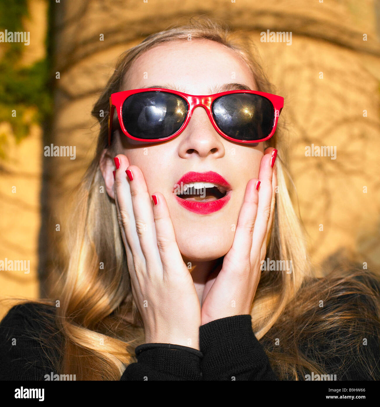 Blond woman with red glasses Stock Photo