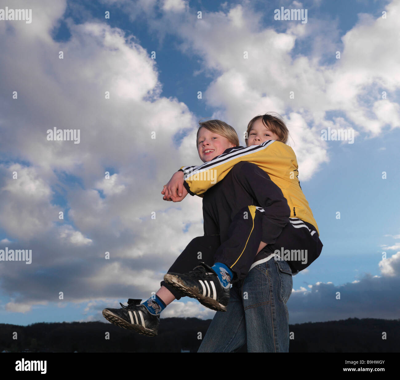 Pyggyback Style Boy carrying girl piggyback style Stock Photo - Alamy