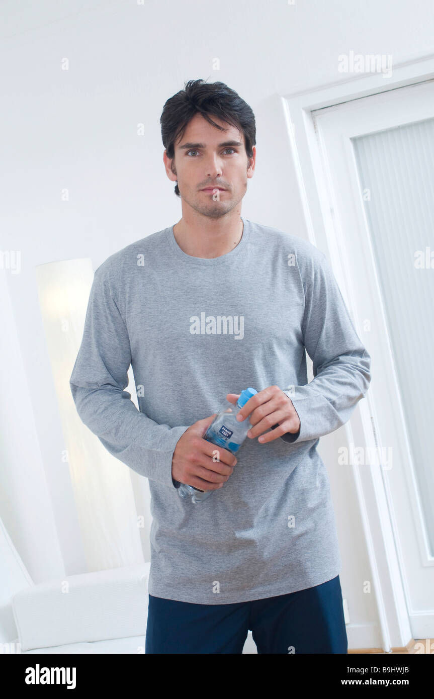 Man with a bottle of water after doing sport Stock Photo - Alamy