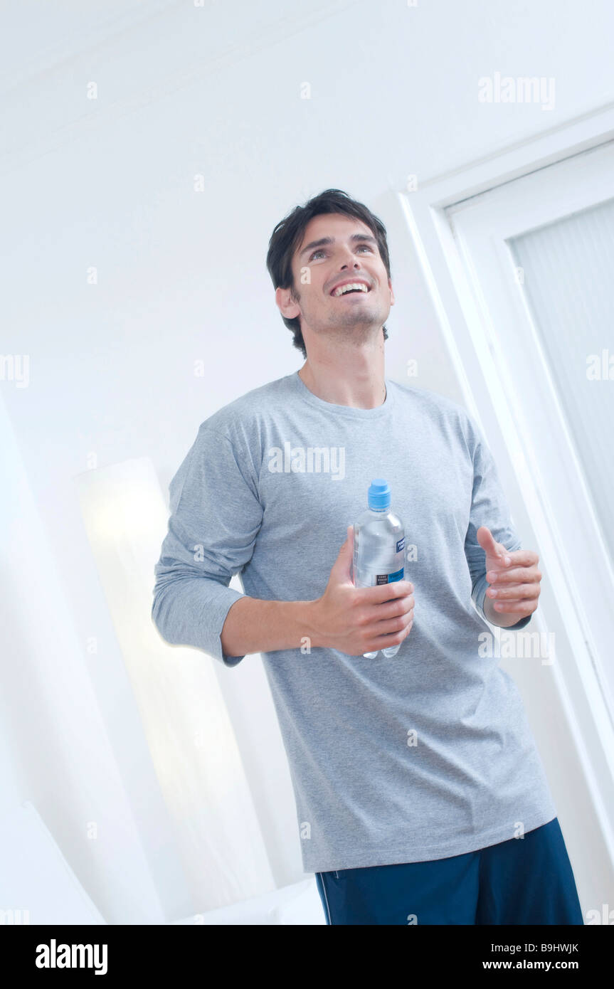 Man with a bottle of water after doing sport Stock Photo - Alamy