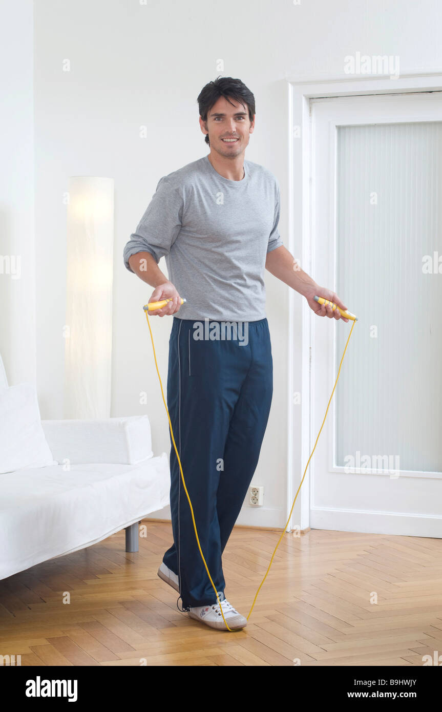 Man wearing sportswear and holding a skipping rope Stock Photo