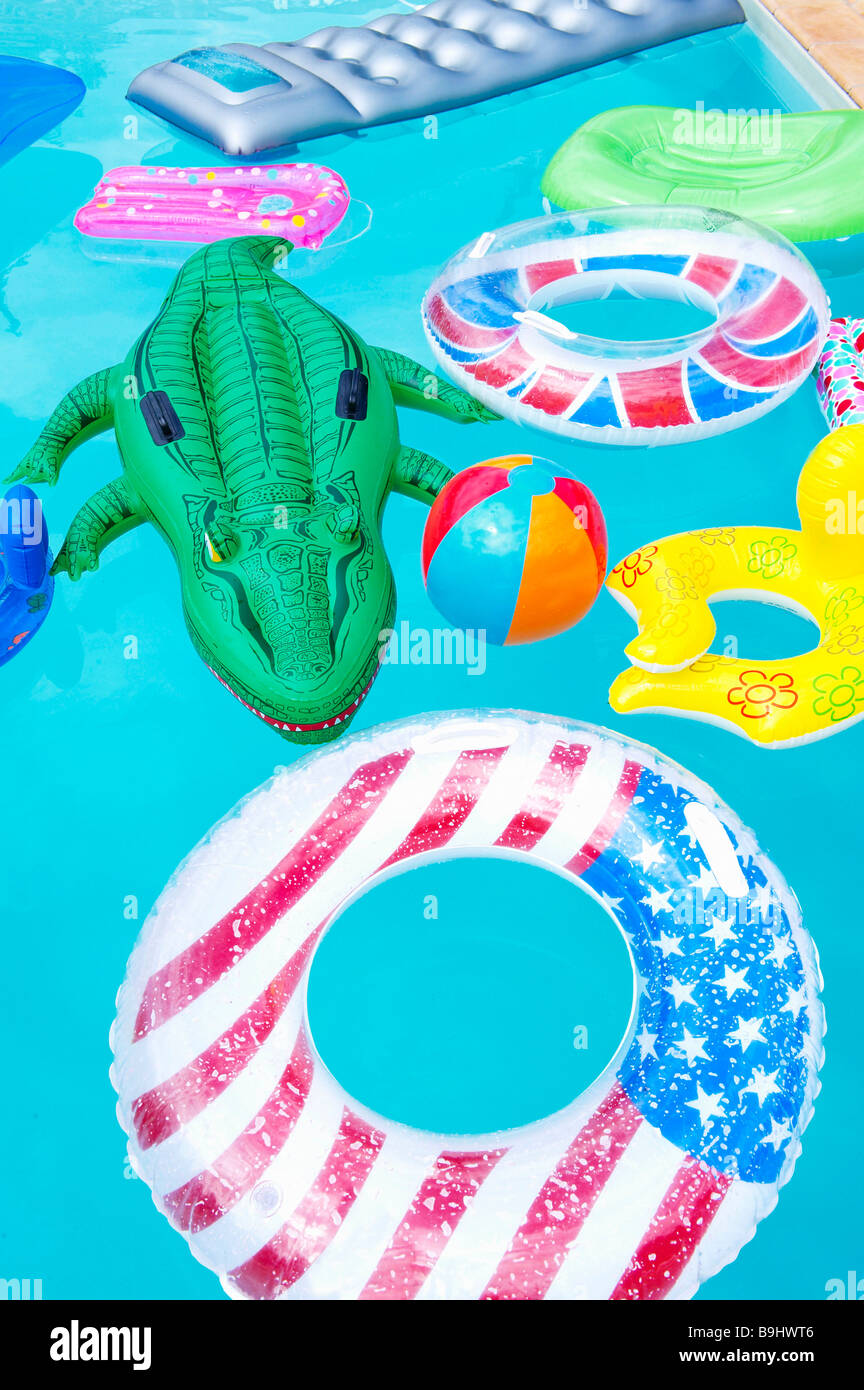 Air mattresses floating on swimming pool Stock Photo Alamy