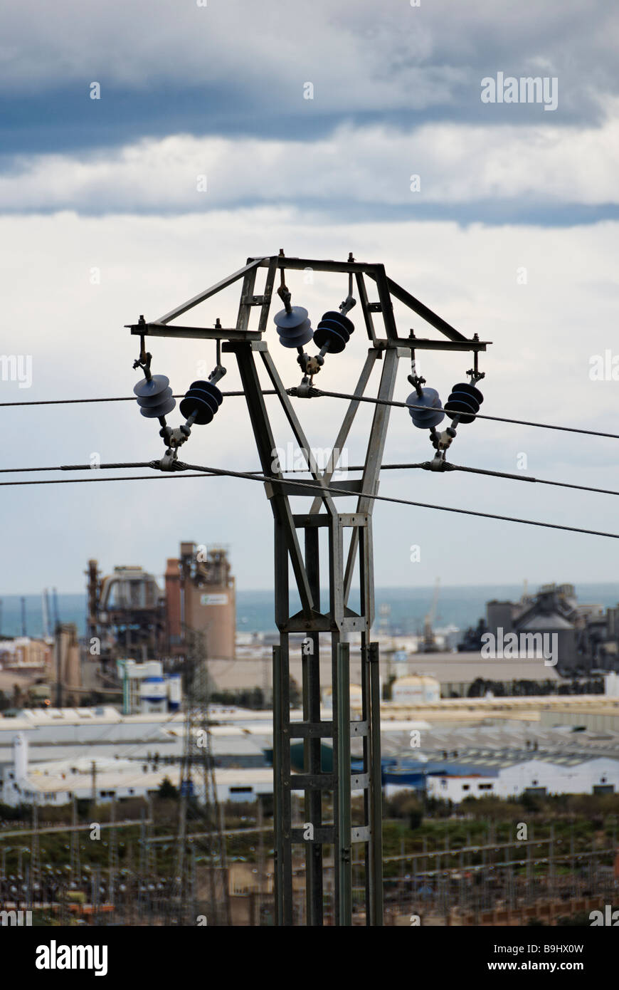View of power line with industrialised Spanish coastline of the Costa Blanca in the background Region of Valencia Stock Photo