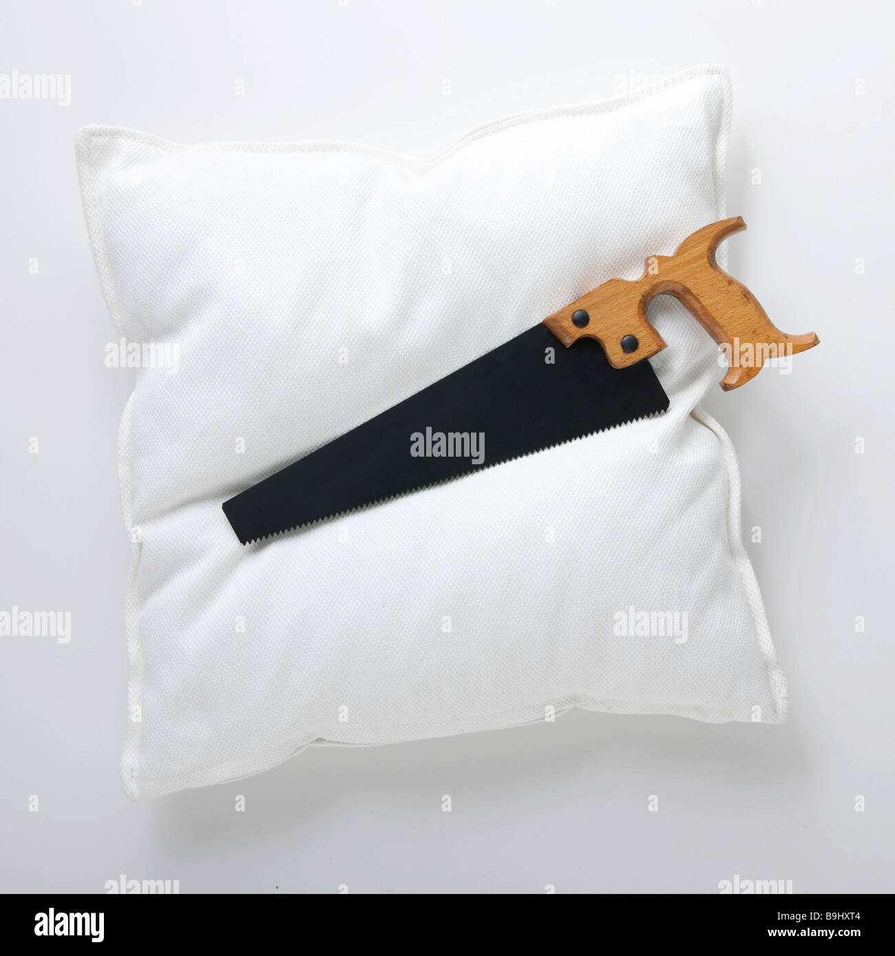 Pillow, saw, symbolic picture for snoring Stock Photo