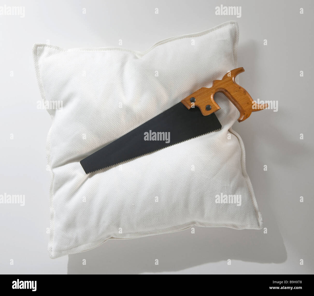 Pillow, saw, symbolic picture for snoring Stock Photo